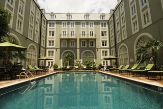 Poolside shot with hotel in background from New Orleans Hotel Collection